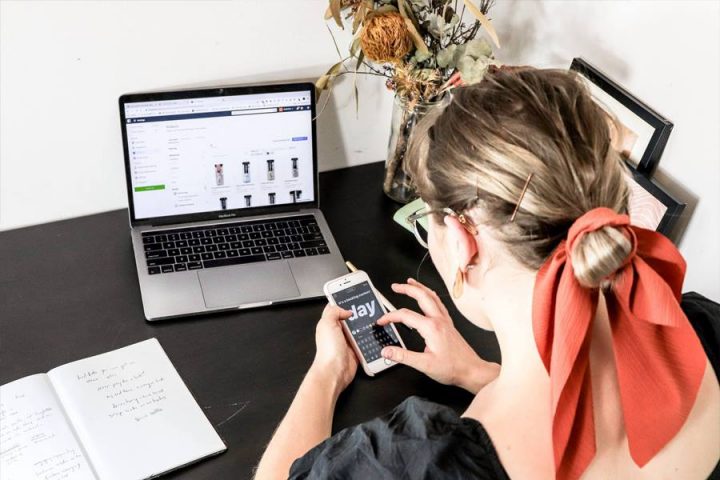 Keep your audience updated woman typing on her phone